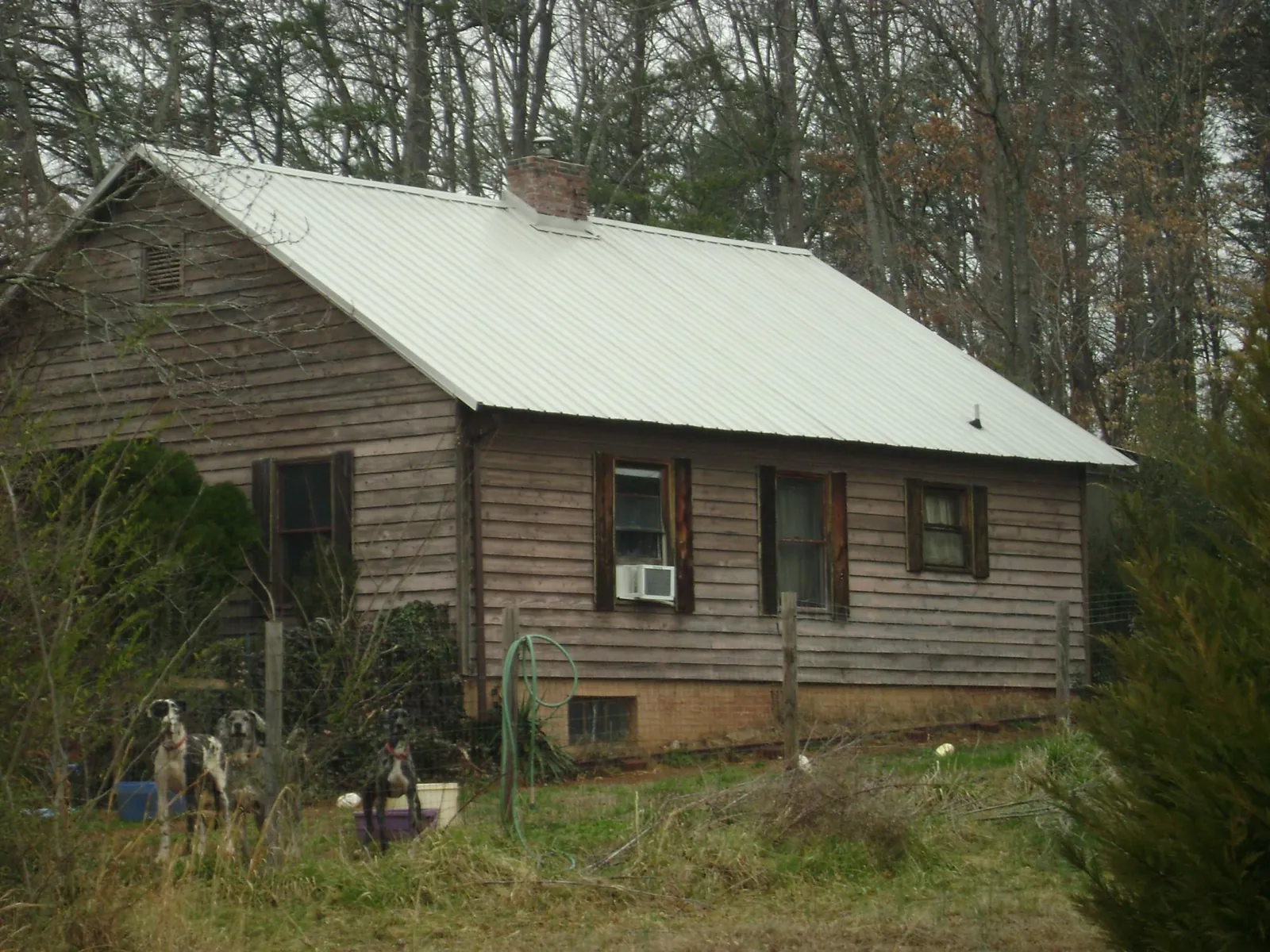 White metal roof on an old wood sided farmhouse, from a Metal Roof Installation job in Moorland
